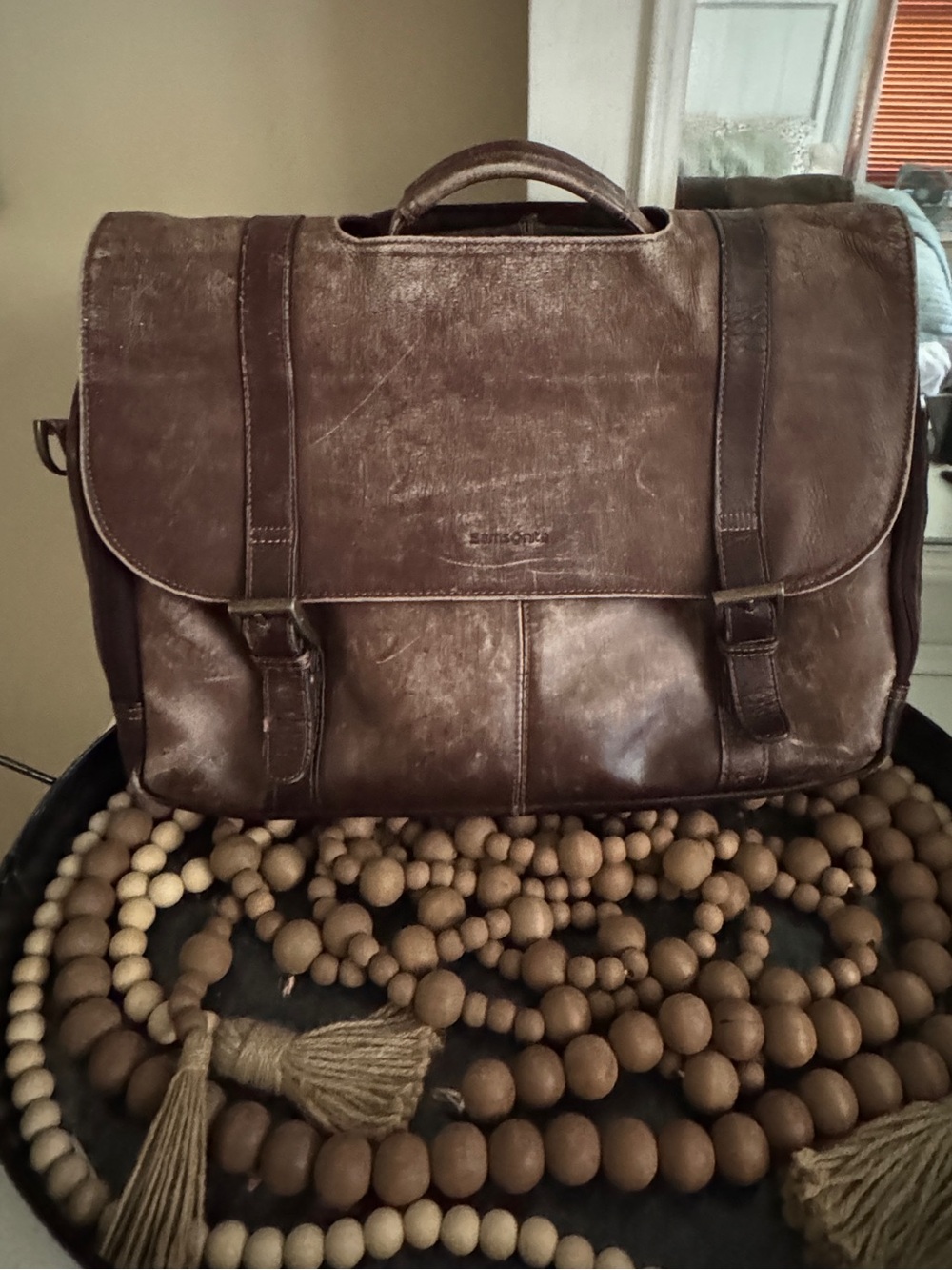 Samsonite brown leather flapover messenger bag with dual buckle straps